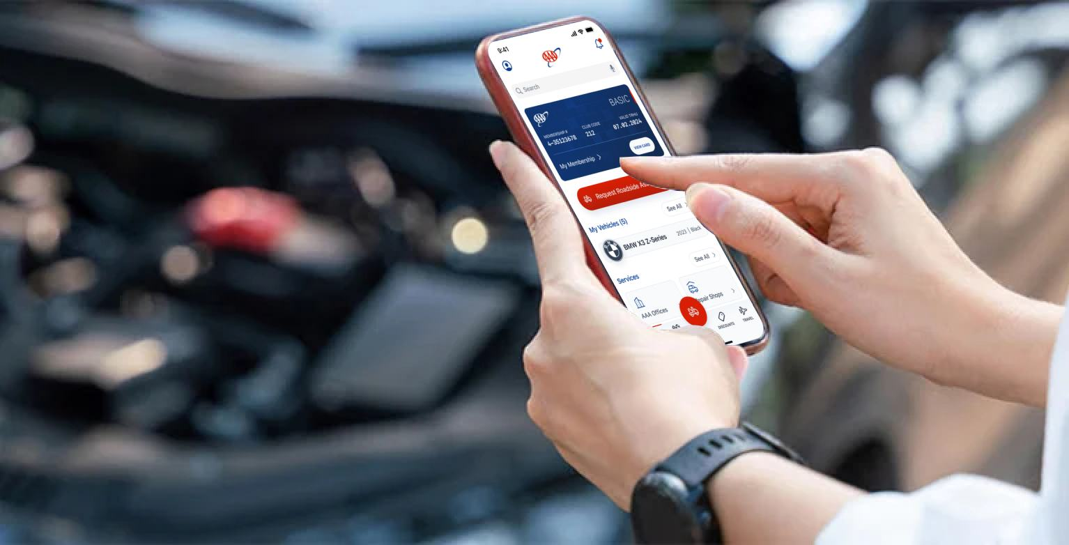 AAA Mobile app redesign — hands holding phone with AAA interface